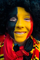 Binche festival carnival in Belgium Brussels. Boy painted with a belgium flag. Music, dance, party and costumes in Binche Carnival. Ancient and representative cultural event of Wallonia, Belgium. The carnival of Binche is an event that takes place each year in the Belgian town of Binche during the Sunday, Monday, and Tuesday preceding Ash Wednesday. The carnival is the best known of several that take place in Belgium at the same time and has been proclaimed as a Masterpiece of the Oral and Intangible Heritage of Humanity listed by UNESCO. Its history dates back to approximately the 14th century.